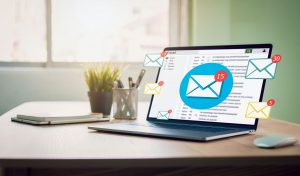 New email alert on laptop, communication connection message to global letters in the workplace