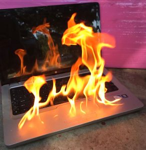 Laptop on fire over the table