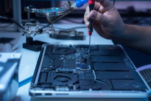 Computer technician fixing the laptop