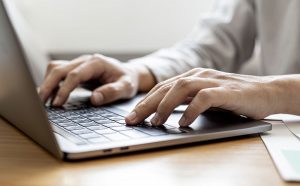 Close-up A businessman working in a private room, He is typing on a laptop keyboard