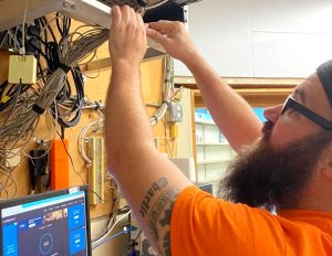 Computer technician checking network cables