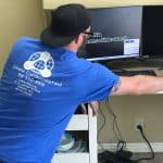 Technician configuring network on computer for Cabala Consolidated services.