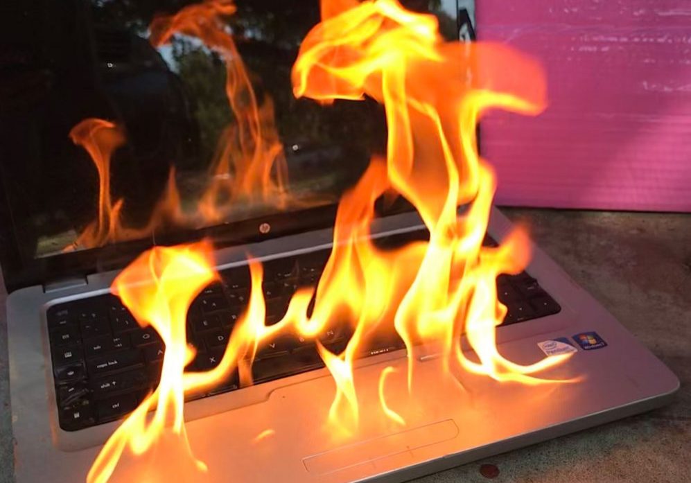 Laptop on fire over the table