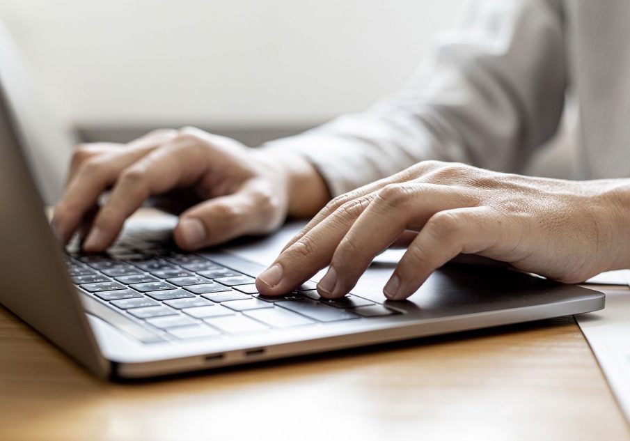 Close-up A businessman working in a private room, He is typing on a laptop keyboard