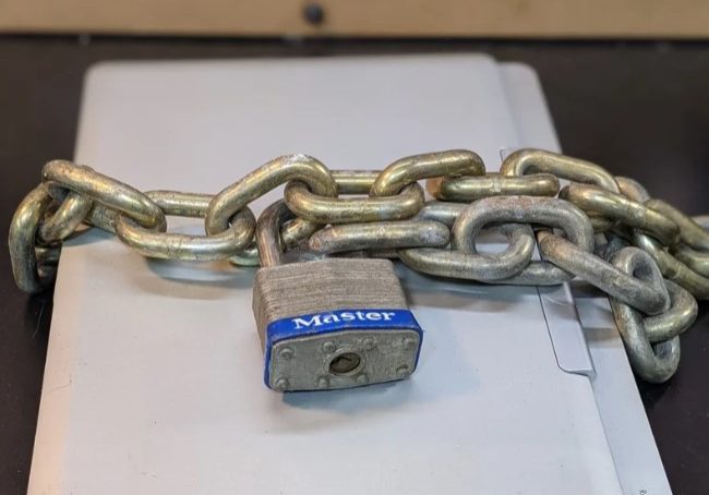 Laptop with padlock on the table